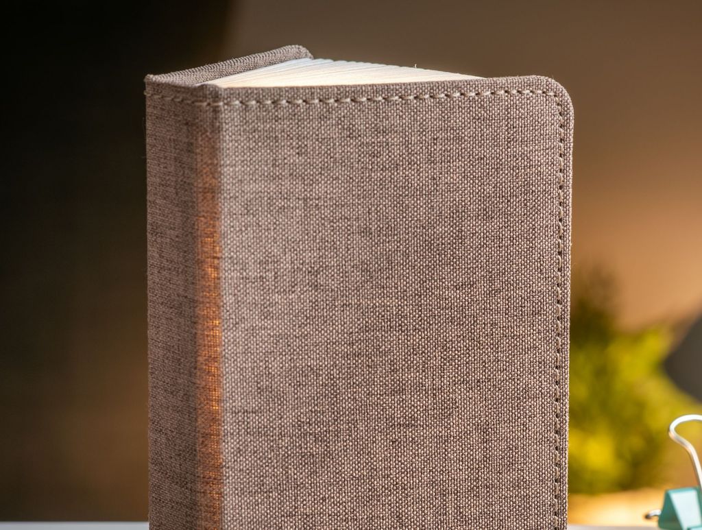 A clever concertina paged light which looks like a book. In linen coffee brown colour. When closed, 9W x 12.2H x 2.5cm
