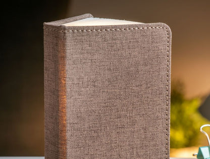 A clever concertina paged light which looks like a book. In linen coffee brown colour. When closed, 9W x 12.2H x 2.5cm